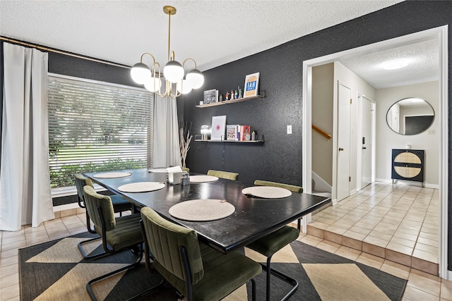 tiled dining area featuring a chandelier and a textured ceiling