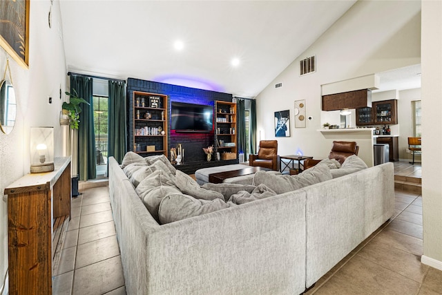 tiled living room featuring high vaulted ceiling