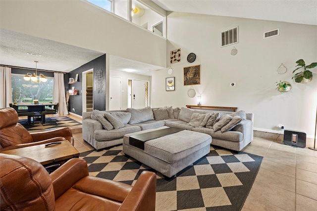 living room with light tile patterned flooring, a textured ceiling, a chandelier, and billiards