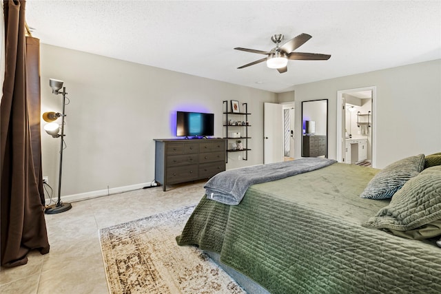 bedroom with a textured ceiling, ensuite bathroom, ceiling fan, and light tile patterned flooring