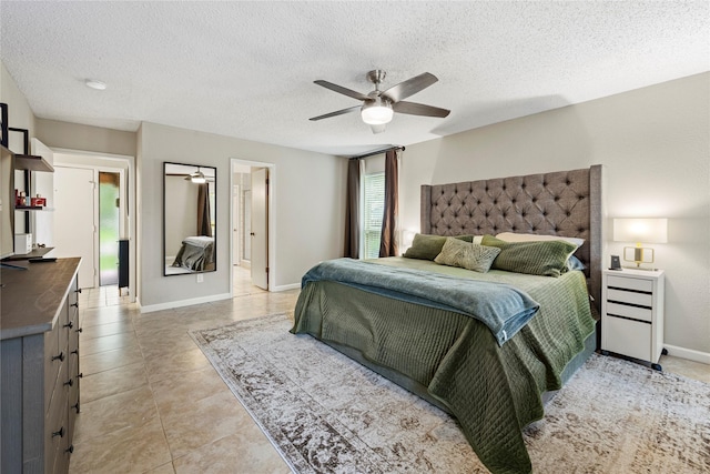 tiled bedroom featuring ceiling fan and a textured ceiling