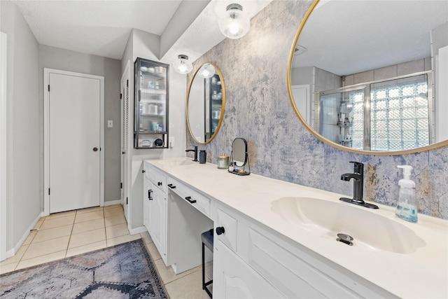 bathroom featuring vanity, a shower with door, and tile patterned flooring