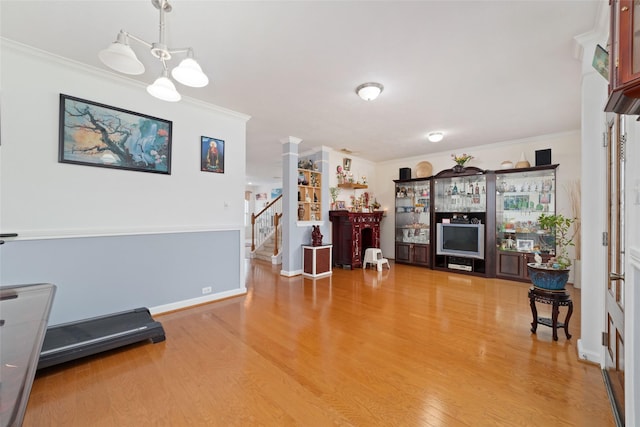 living room featuring hardwood / wood-style flooring and ornamental molding