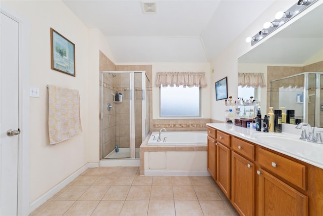 bathroom featuring tile patterned floors, separate shower and tub, vanity, and lofted ceiling