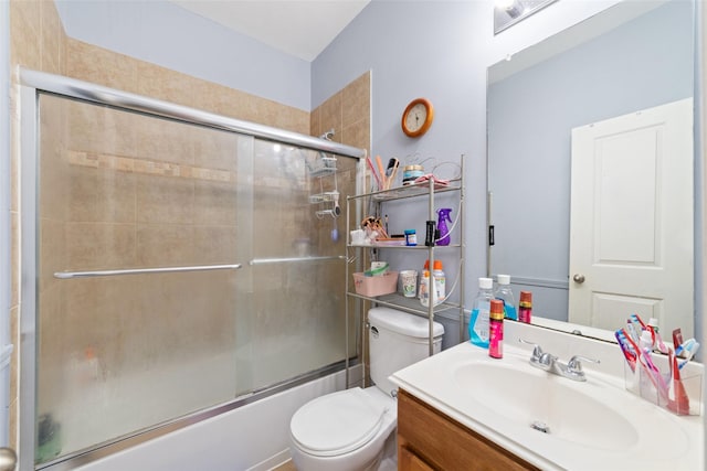 full bathroom with shower / bath combination with glass door, vanity, and toilet