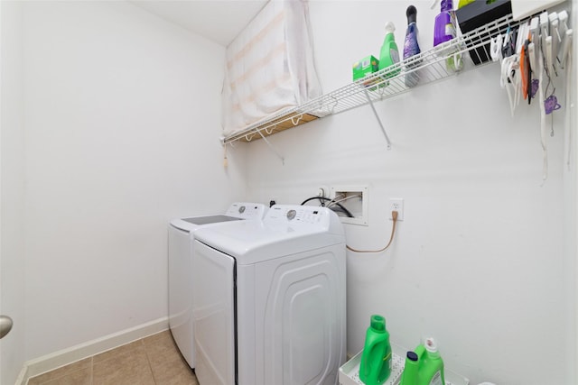 washroom with washer and dryer and light tile patterned floors