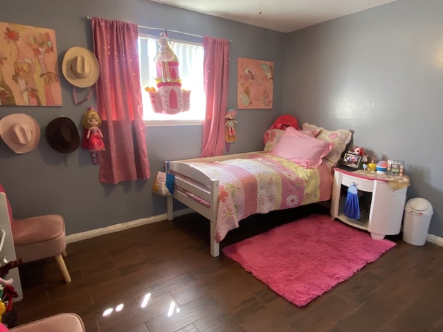 bedroom with dark hardwood / wood-style flooring