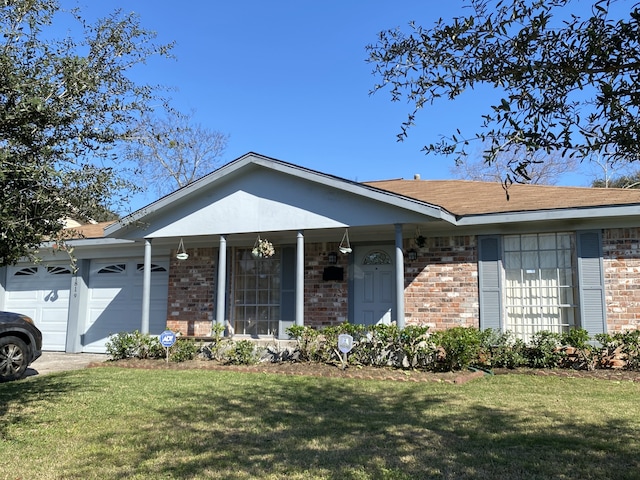 single story home featuring a garage and a front lawn