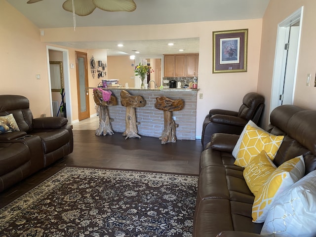 living room featuring dark hardwood / wood-style flooring, sink, and ceiling fan