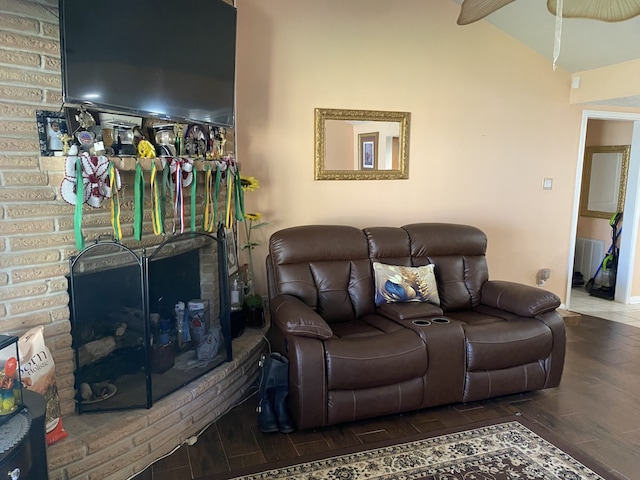 living room featuring lofted ceiling, dark hardwood / wood-style floors, and a fireplace