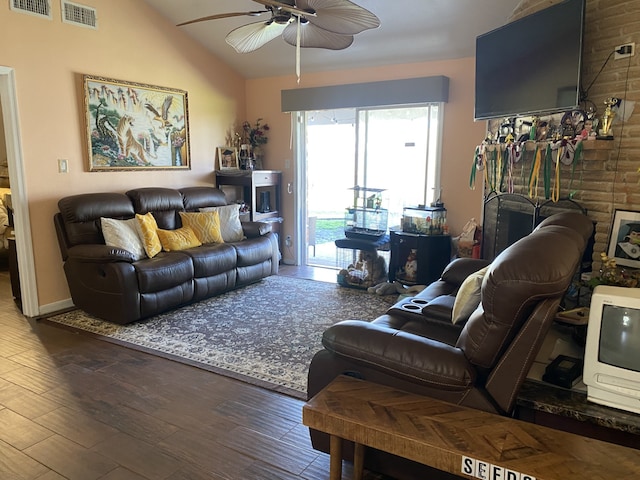 living room featuring hardwood / wood-style flooring, vaulted ceiling, and ceiling fan