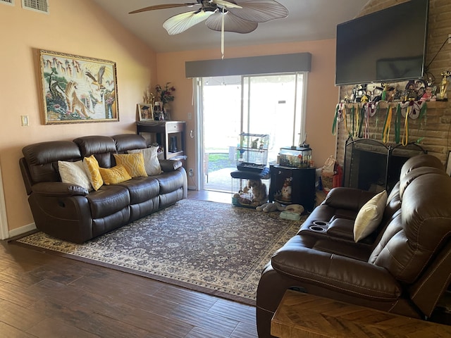 living room with ceiling fan, vaulted ceiling, and wood-type flooring