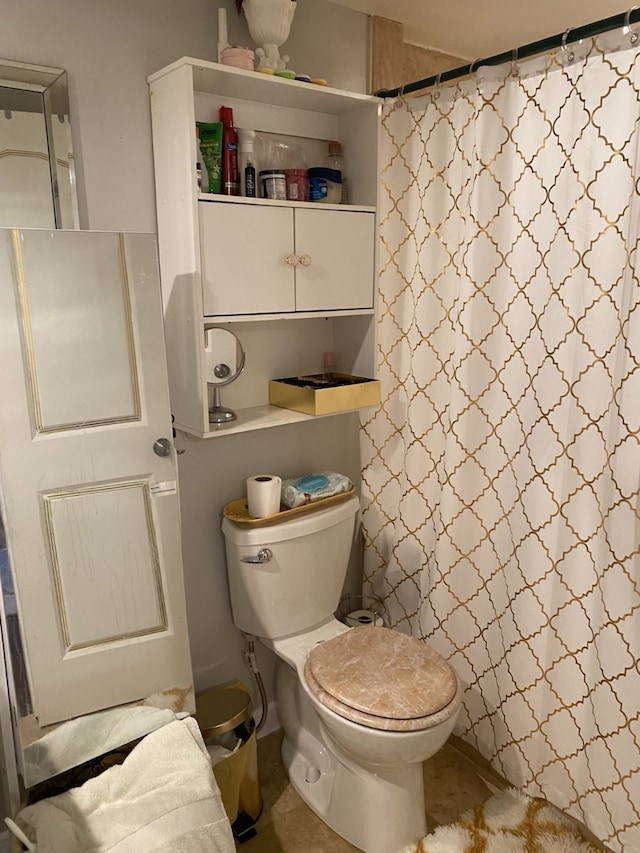 bathroom with a shower with curtain and toilet