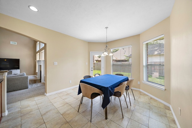 dining room featuring light tile patterned floors and a notable chandelier