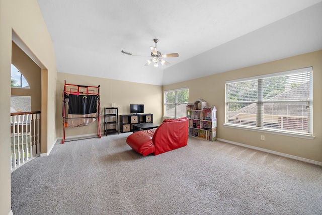 sitting room with ceiling fan, light colored carpet, and lofted ceiling