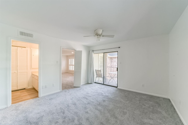 unfurnished bedroom featuring connected bathroom, access to exterior, carpet floors, and ceiling fan