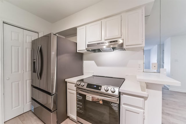 kitchen with appliances with stainless steel finishes, white cabinets, light hardwood / wood-style floors, and kitchen peninsula