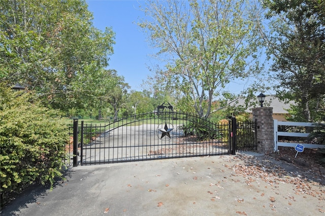 view of gate with fence