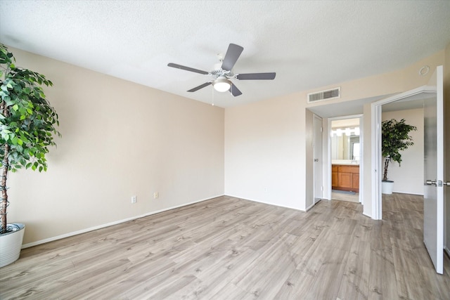 unfurnished bedroom featuring a textured ceiling, ceiling fan, light wood-type flooring, and visible vents