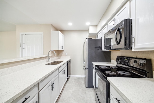 kitchen featuring recessed lighting, a sink, white cabinetry, baseboards, and black appliances