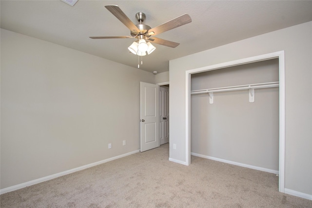 unfurnished bedroom with ceiling fan, a closet, and light carpet