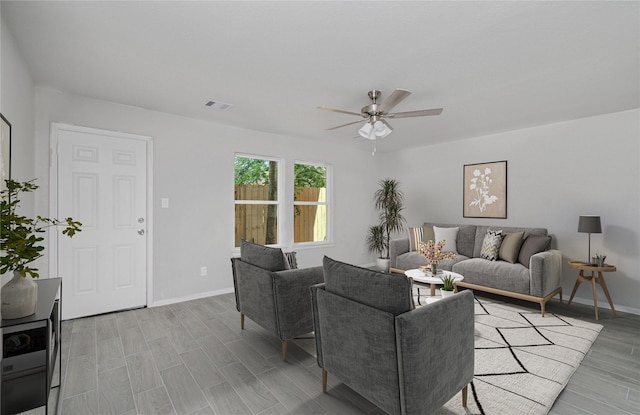 living room featuring ceiling fan and light wood-type flooring