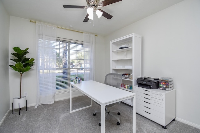 office space with light carpet, ceiling fan, and baseboards