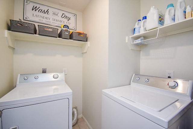 laundry room with light tile patterned floors, laundry area, independent washer and dryer, and baseboards