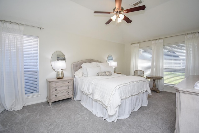 bedroom with a ceiling fan, carpet, visible vents, and vaulted ceiling