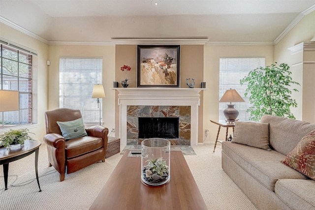 living area with carpet floors, crown molding, and a stone fireplace