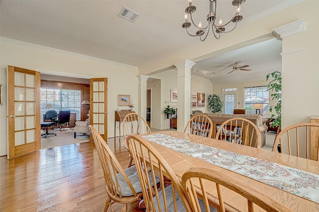 dining space with french doors, visible vents, ornate columns, and a healthy amount of sunlight