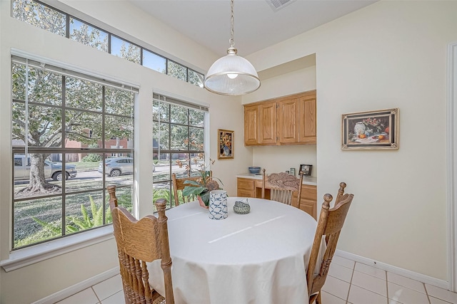 dining room with light tile patterned flooring and baseboards