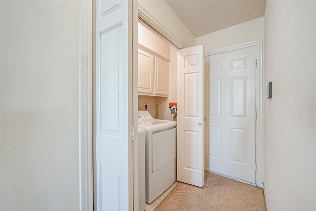 laundry area featuring washing machine and dryer and cabinet space