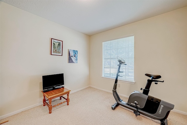 exercise area with carpet floors and baseboards