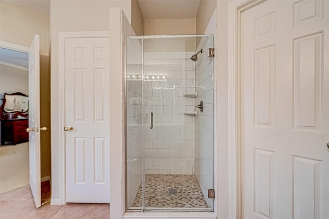 full bath with a shower stall and tile patterned floors