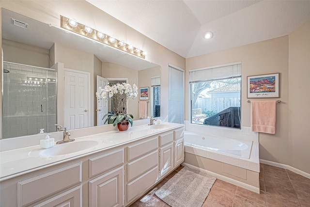 bathroom featuring lofted ceiling, visible vents, a sink, and a shower stall