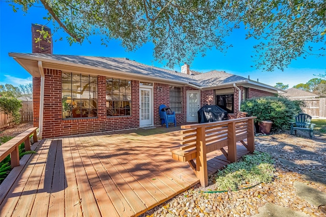 wooden terrace with fence and area for grilling