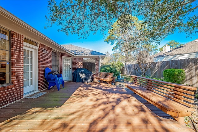 wooden deck featuring fence and area for grilling