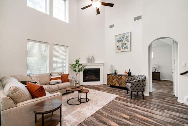 living room featuring dark hardwood / wood-style floors and ceiling fan