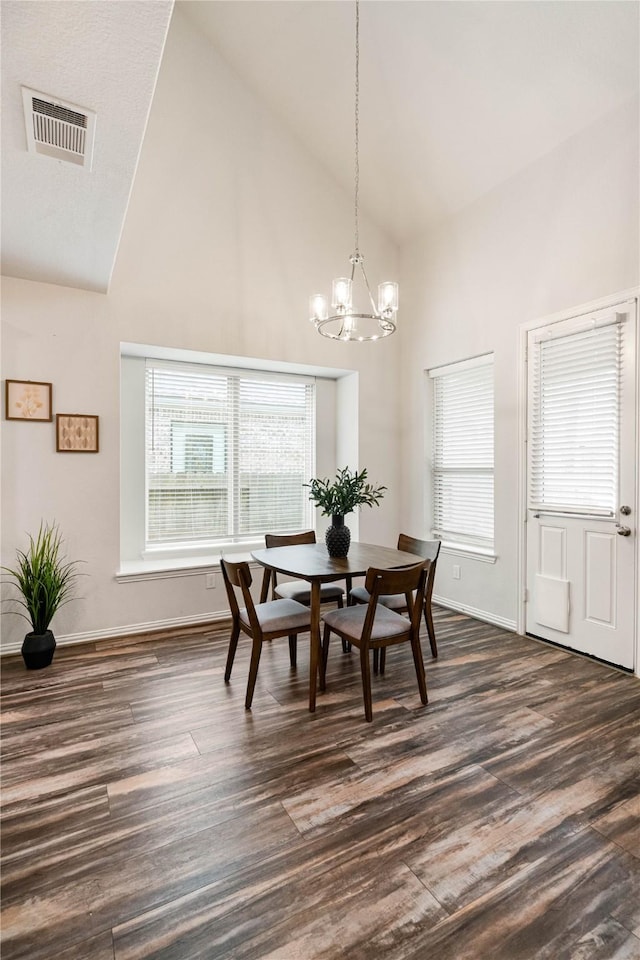 dining area featuring plenty of natural light, dark hardwood / wood-style floors, and high vaulted ceiling