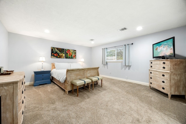 bedroom with light colored carpet, visible vents, and baseboards