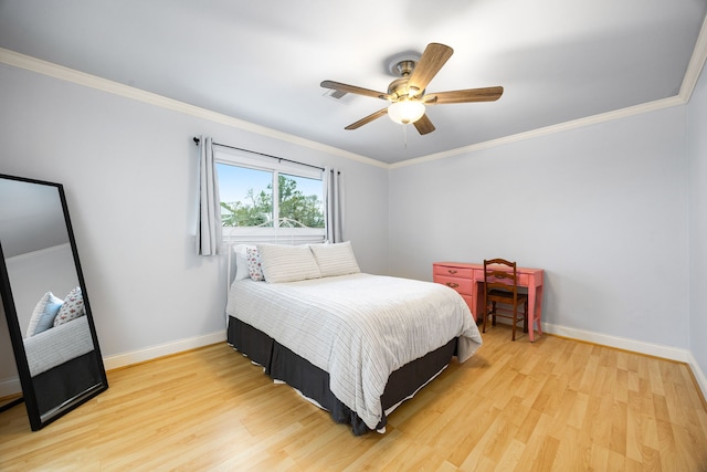 bedroom featuring ornamental molding, wood finished floors, a ceiling fan, and baseboards