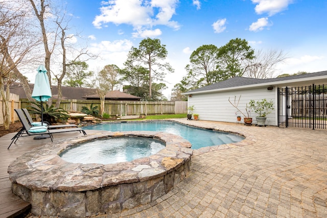 view of pool featuring a fenced backyard, a patio, a fenced in pool, and an in ground hot tub