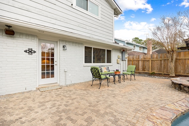 view of patio / terrace featuring fence