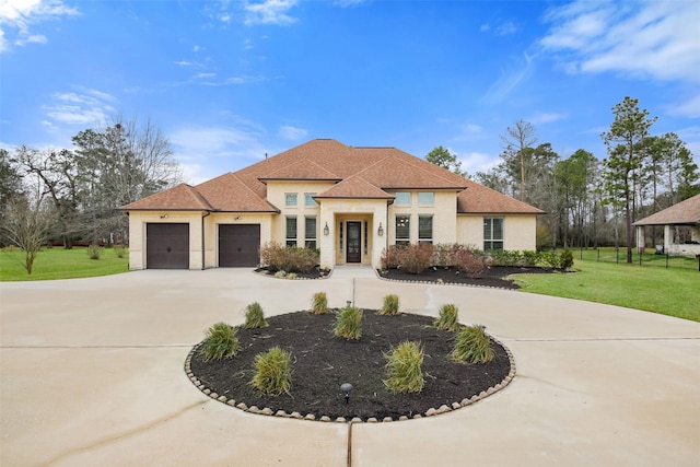 mediterranean / spanish house with a garage and a front yard