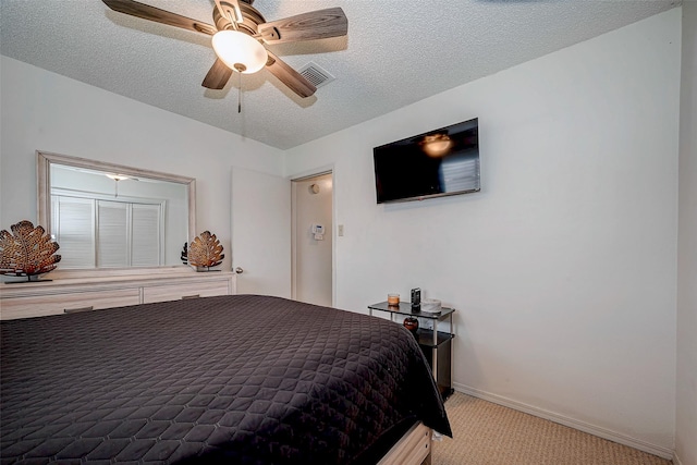 bedroom featuring a textured ceiling, ceiling fan, light colored carpet, visible vents, and baseboards