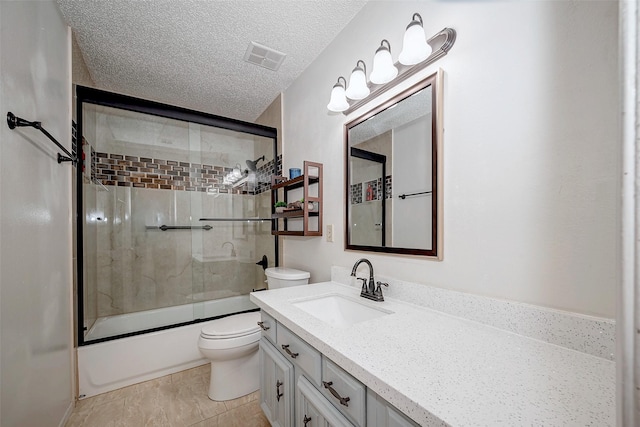 bathroom featuring a textured ceiling, toilet, shower / bath combination with glass door, vanity, and visible vents