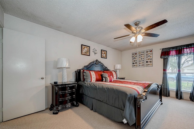 bedroom featuring carpet, ceiling fan, and a textured ceiling