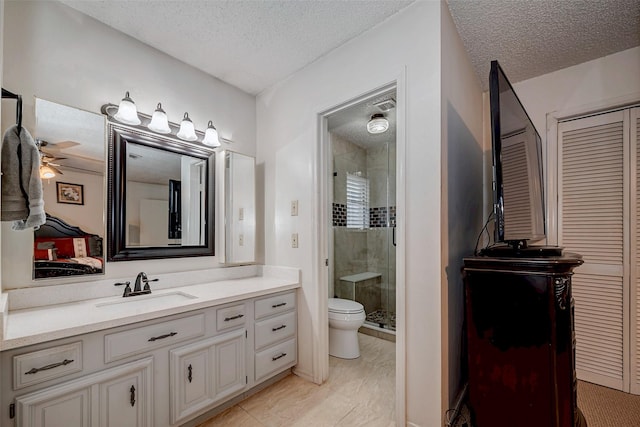 bathroom featuring a closet, toilet, a shower stall, vanity, and a textured ceiling