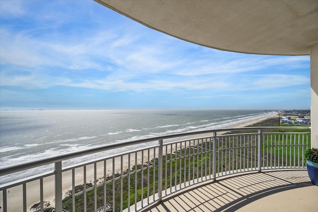 balcony with a beach view and a water view